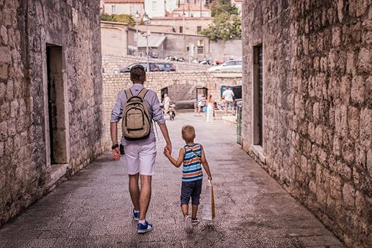 Parent and child walking through old town