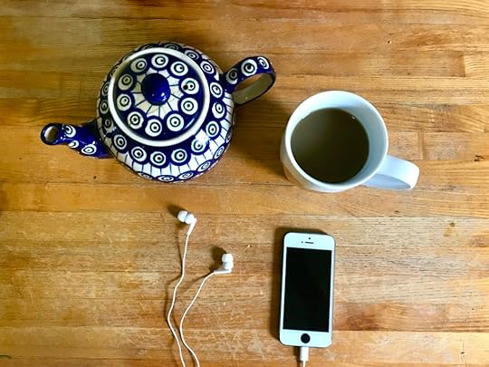 image of a teapot, mug of tea, phone and headphones to listen to podcast podcasts