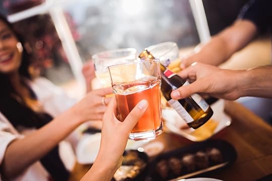 People clinking glasses playing drinking games