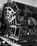 A man is standing on a bucket of a paddlewheel
