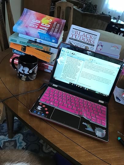 I usually write at the kitchen table these days, surrounded by books and journals.