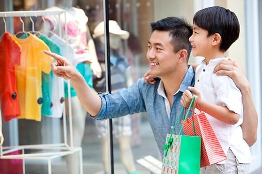 Father and son shopping in department store