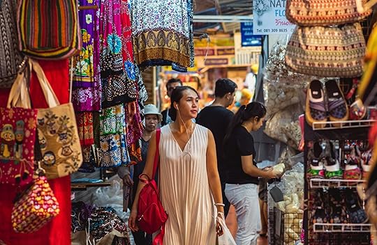 Person walking along stalls and stands of Chatuchak market