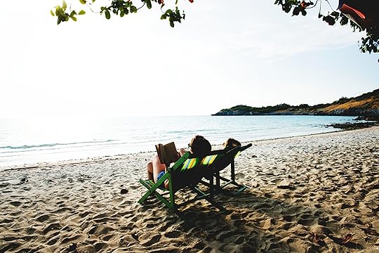 People Lying On Green Wooden Lounger Chairs On Beach