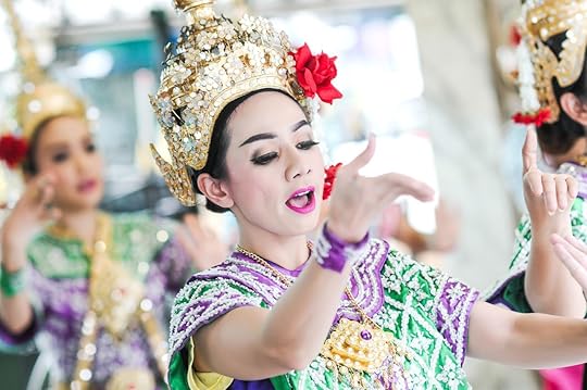 A woman dancing to famous Erawan shrine at Ratchaprasong