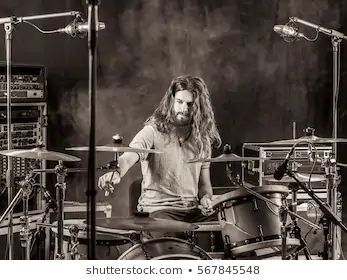 long haired male drummer