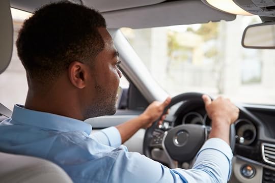 backseat view of man driving