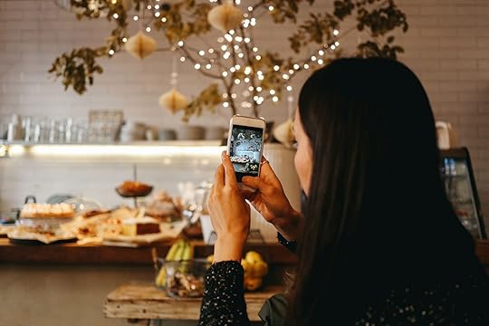 woman taking a photo with her phone