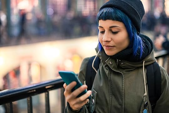 Girl with blue hair using smartphone