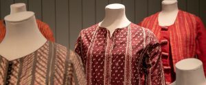 ditchling museum exhibit: women's work, shown are several garments from the exhibit on dress forms