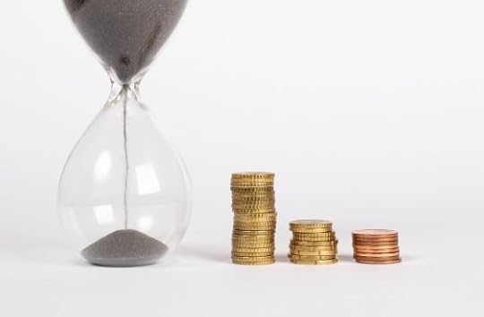 Hourglass with coins, estimate time and cost for copyediting