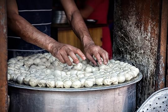 Man cooking steamed traditional Nepalese momos in the street kitchen