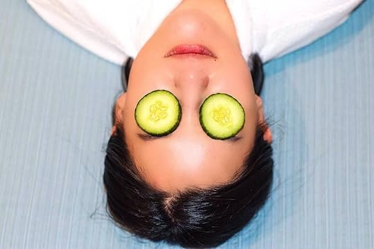 Person with cucumbers on eyes