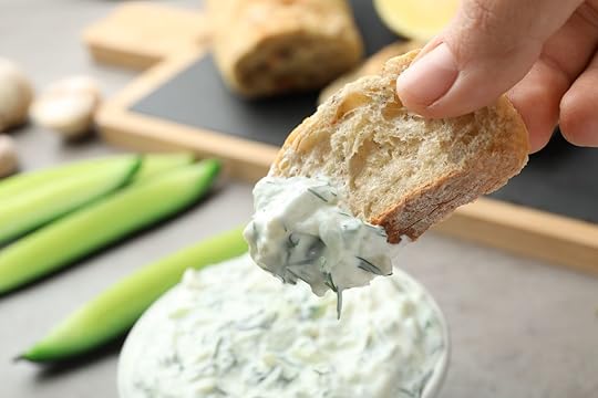 Bread dipped in tzatziki