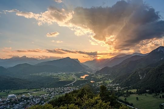 Vivid, layered mountain at sunset with village beneath them