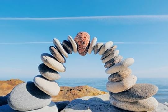 Red round stone in center of arching cairn