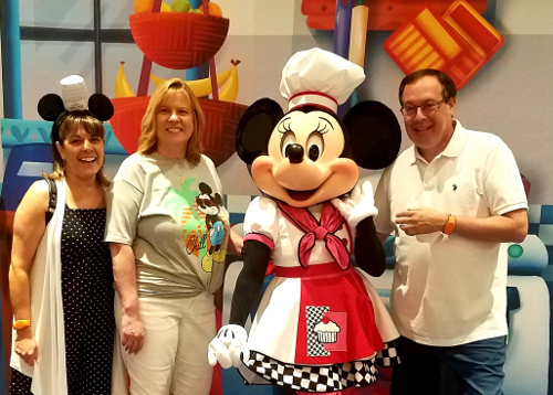 Howard, Kelly, and Patty standing with Chef Minnie Mouse at the Epcot International Food & Wine Festival
