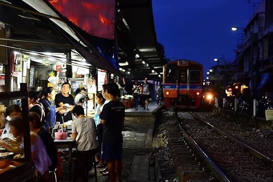 Train is arriving to local street food market at talat phlu station