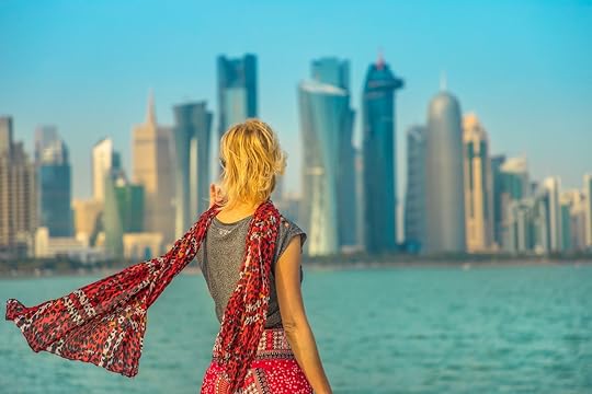 Person looking at modern skyscrapers of Doha West Bay