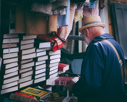 Man choosing a book, title, mystery title