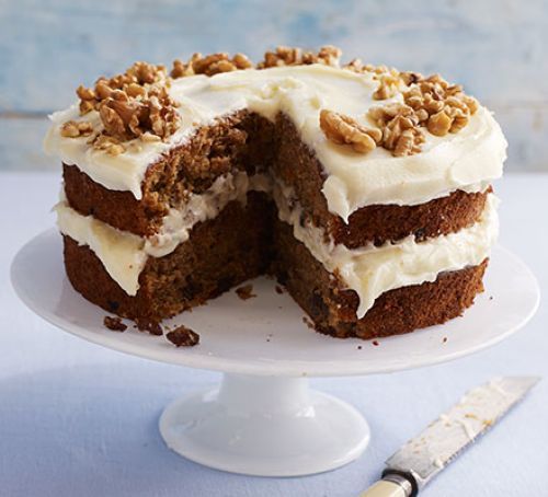 Carrot cake with cream cheese frosting on a cake stand