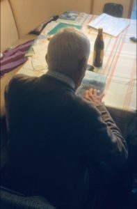 old man looking at book