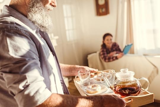 Husband bringing tea to resting wife