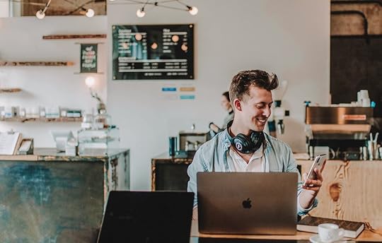 happy man looking at mobile phone, receive an email