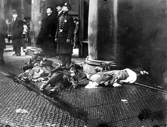 A police officer and others with the broken bodies of Triangle fire victims at their feet, look up in shock at workers poised to jump from the upper floors of the burning Asch Building. (Credit: Cornell University ILR School Kheel Center ©2011)