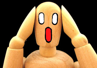 Wood doll with a bothered face