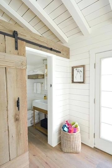 wood paneling for walls and ceilings whitewashed panels cover the ceiling of this cottage a rustic barn door slides open to reveal white bathroom wa