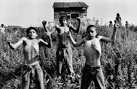 black and white image of three young boys flexing their arms