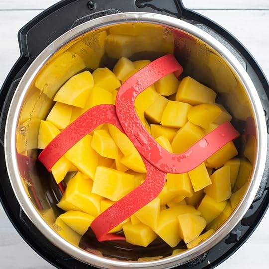 Overhead view of the bright orange cubed pieces of cooked Instant Pot Rutabaga inside the inner pot after it has been pressure cooked.