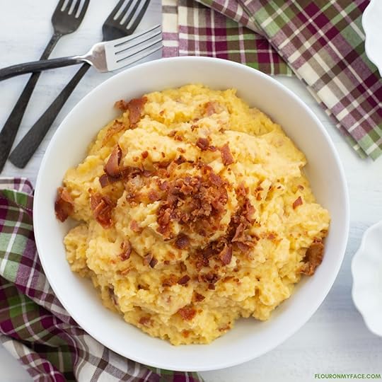 a serving bowl filled with mashed rutabaga recipe with roasted garlic and bacon