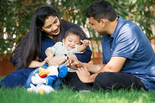 Image may contain: 2 people, people smiling, people sitting, grass, child and outdoor