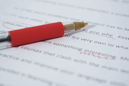 Document with a red pen and red pen marks.