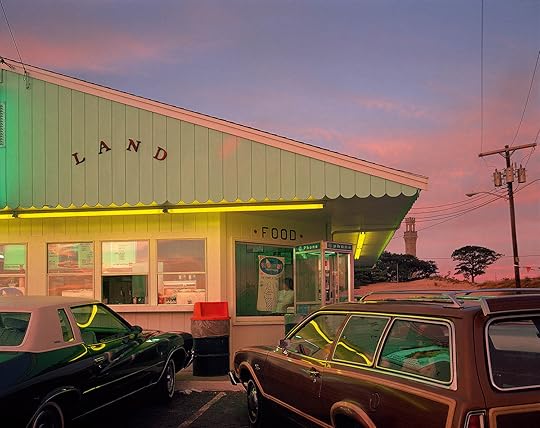a store at sunset, lit by neon lights