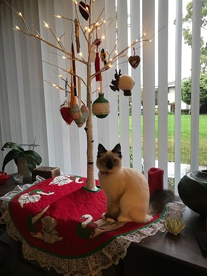 Cleo (@cleoqueenofcats on Instagram) guarding her Christmas tree.