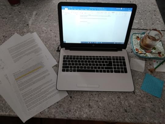 M.Q. Barber's oh-so-fancy workspace: one laptop, a handful of Post-It notes, a pad of blank notes and a pencil, and printouts of notes for the chapter in the works. Oh, and caffeine. That's a must.