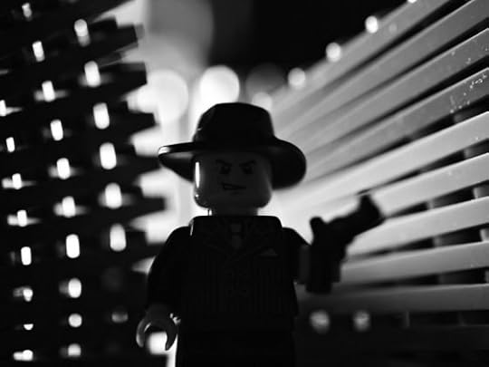 Image: Lego man holding gun in film noir lighting