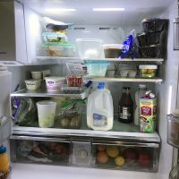 fridge showing empty space among groceries