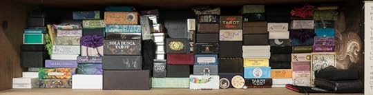 A bookcase shelf stacked to the gills with tarot and oracle decks. Almost no space left for new decks.