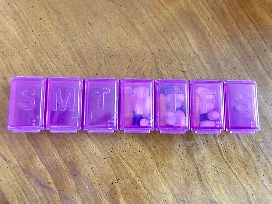 The nice friendly purpley-pink pill planner that usually helps me remember all my meds.