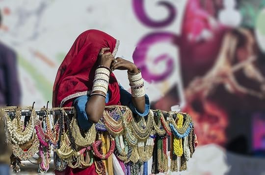 Woman in traditional Indian saree dresses selling ornamental necklaces