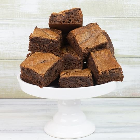 Freshly baked Nutella Brownies on a white glass cake stand