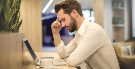 Stressed man at risk of suicide siting at desk