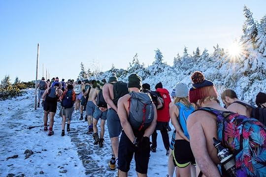 large group of people walking and doing wim hof method of breathing in the cold