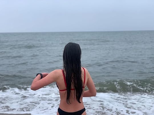 girl in front of cold ocean doing Wim hof method
