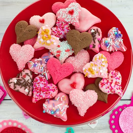 Valentines Day Spritz Cookies overhead photo with the Valentines day treats piled on a red cake stand