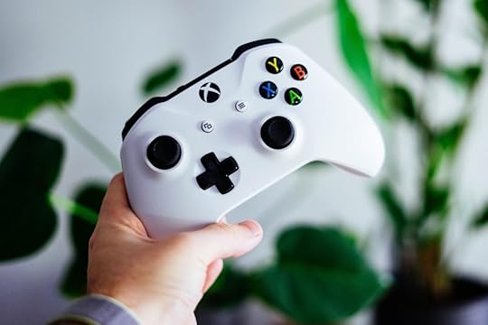 An image of hand holding an Xbox controller